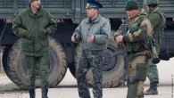 A Ukrainian officer speaks with Russian troops at the Belbek airport in the Crimea region